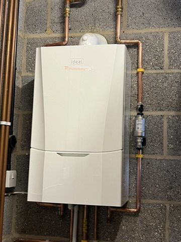 Boiler installed in a utility room with matching pipework
