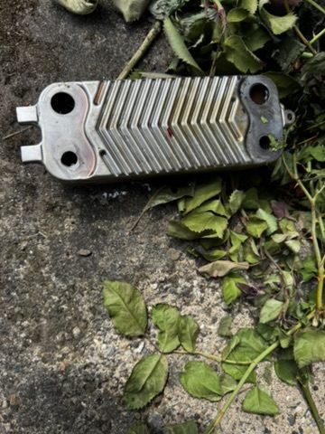 Heat exchanger removed from a boiler, caked in limescale build-up